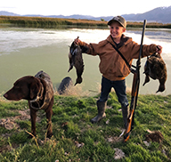 Young hunter holding ducks