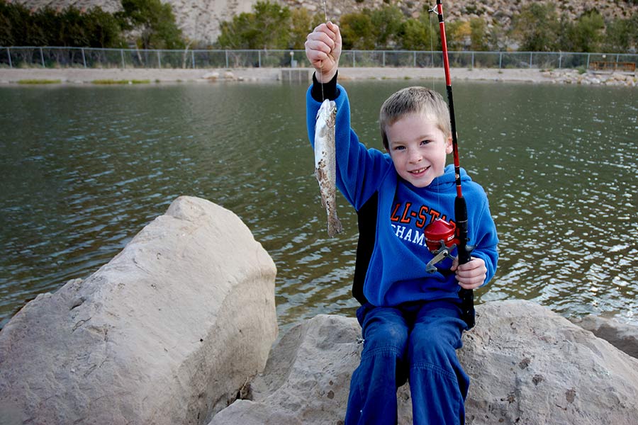 Boy holding a fish caught at Gigliotti Pond