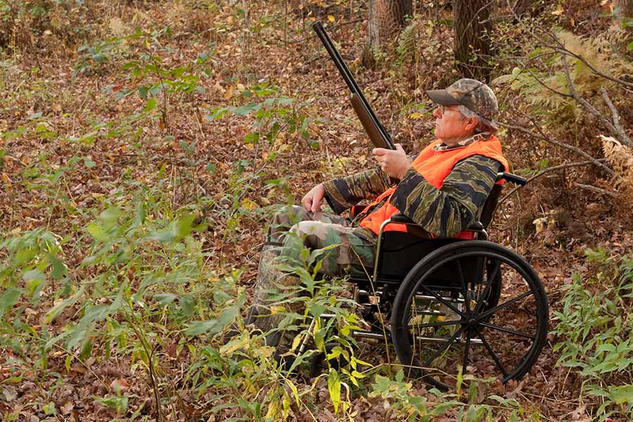 Man in wheelchair with a rifle