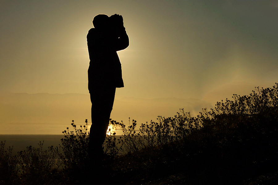 Silhouette of man with binoculars