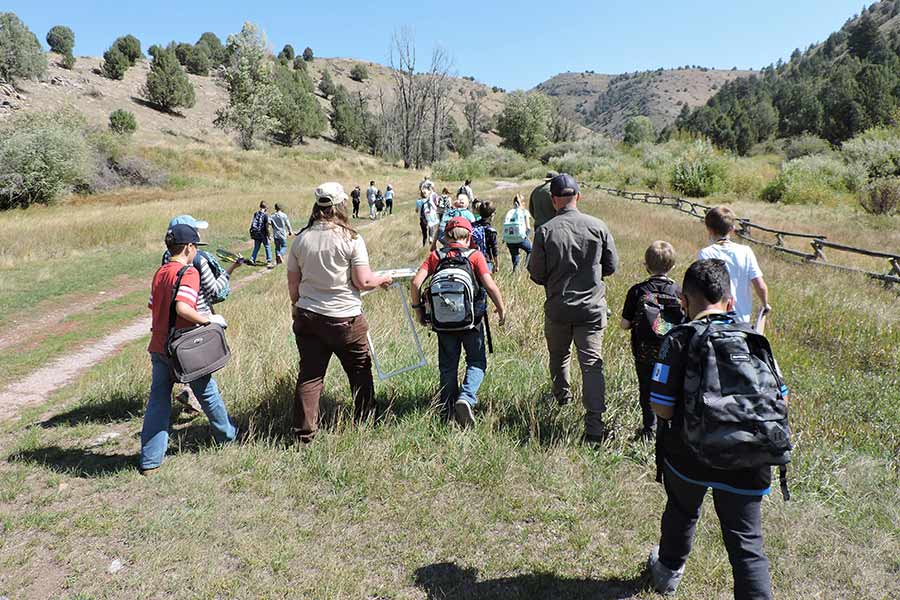 School children and teachers/guides on a field trip at Hardware WMA, walking along a trail