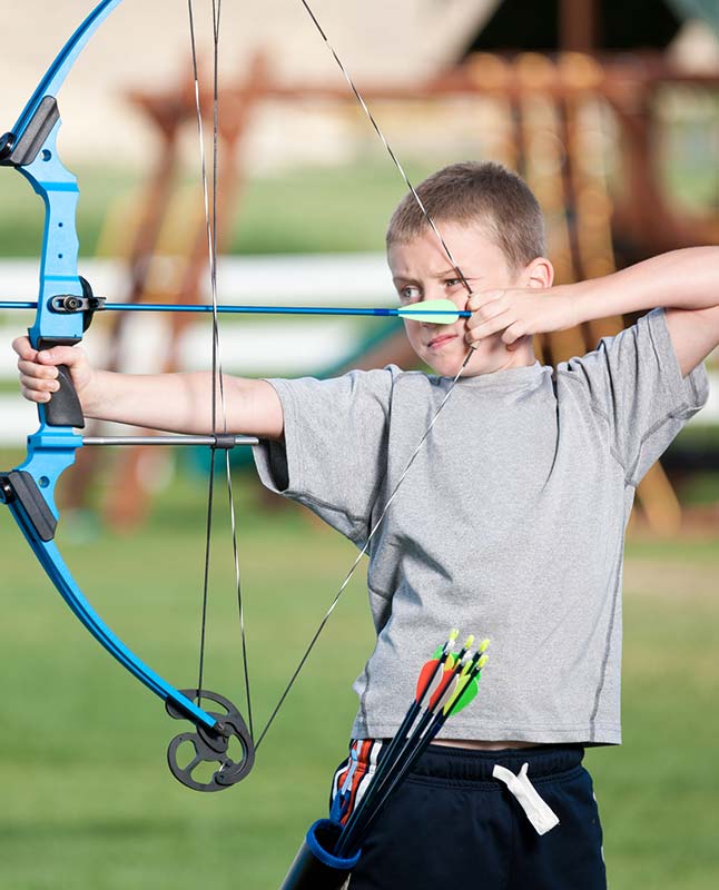 Boy shooting a bow and arrow