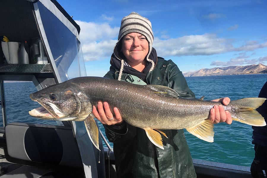 DWR technician holding lake trout caught and released at Bear Lake